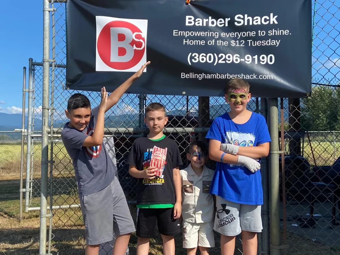 Barber Shack at the local Autism Walk with a banner reading Empowering everyone to shine, Home of the $12 Tuesday.