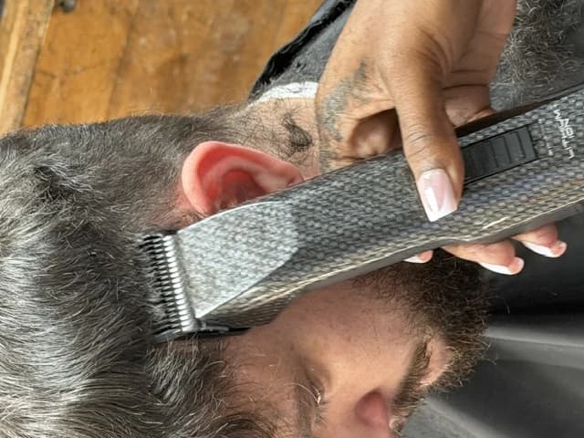Clippers detailing the side of a client's cut at Barber Shack.