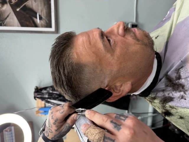 Clipper-over-comb work shaping a client's fade at Barber Shack.
