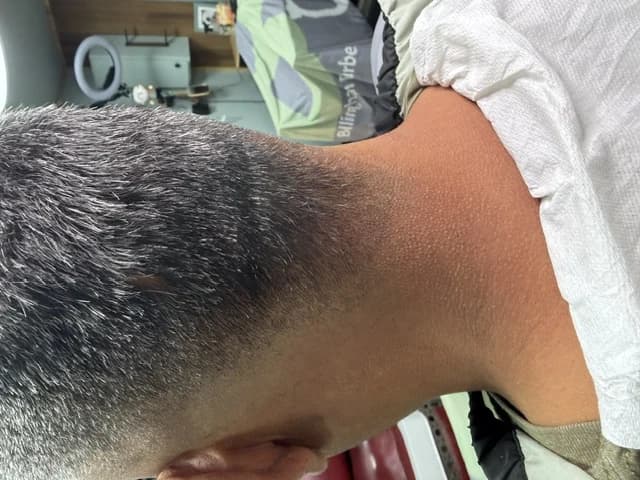 A tapered fade blended down to the nape, finished at Barber Shack.