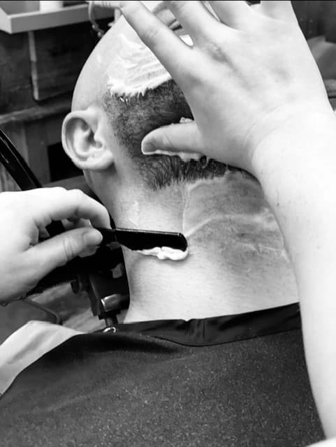 A close razor shave along the neckline, in black and white.