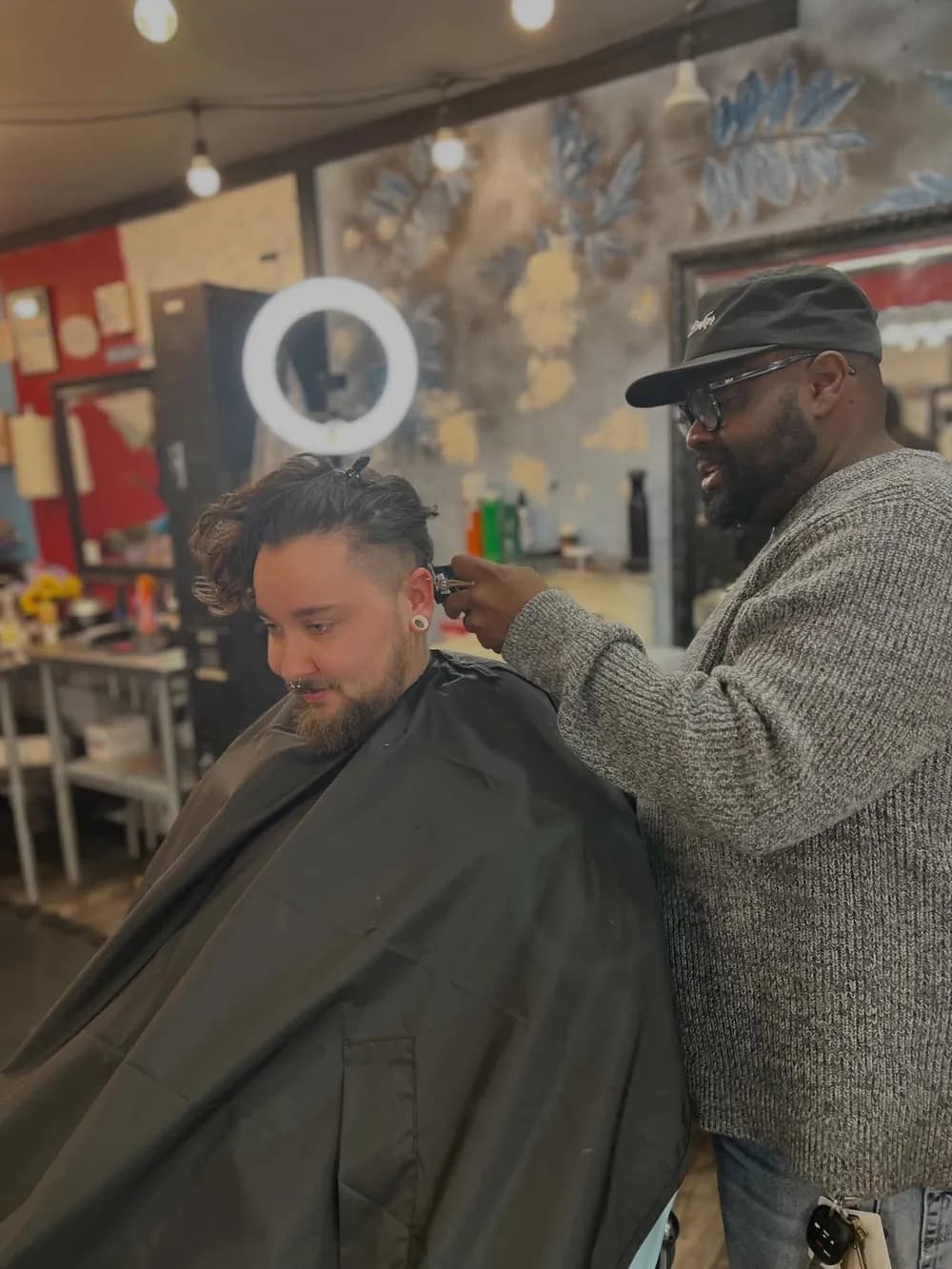 A barber lining up a client's cut with clippers at Barber Shack in Bellingham.