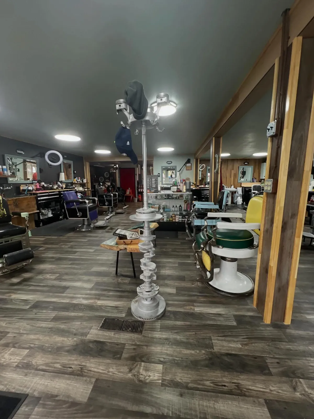 Inside Barber Shack: the shop floor with vintage barber chairs and station mirrors at 2500 Cedarwood Ave.