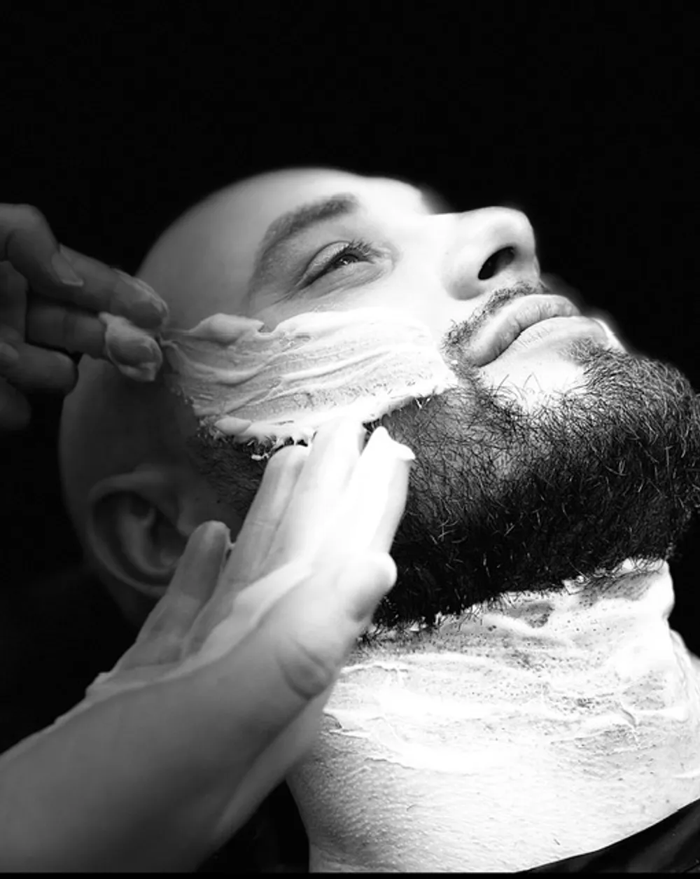 A traditional hot-towel straight-razor shave at Barber Shack, in black and white.